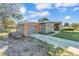 Exterior view of the house featuring a convenient attached garage and a neatly paved driveway at 3134 Hilltop S Ave, Lakeland, FL 33803