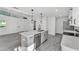 Open-concept kitchen featuring white cabinets, quartz countertops, stainless appliances and recessed lighting at 3134 Hilltop S Ave, Lakeland, FL 33803