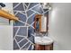 Stylish half bathroom featuring a unique geometric wall design and a corner sink at 3530 Hamilton Rd, Lakeland, FL 33811