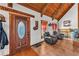 Inviting entryway with wood accents, tile floors, comfortable seating, and charming decor at 3530 Hamilton Rd, Lakeland, FL 33811