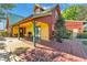 Charming exterior view of the yellow and red home with porch at 3530 Hamilton Rd, Lakeland, FL 33811