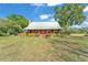 Exterior of home with a metal roof and large front yard at 3530 Hamilton Rd, Lakeland, FL 33811