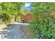 Asphalt driveway leading to a red garage attached to the main home at 3530 Hamilton Rd, Lakeland, FL 33811