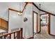 Upstairs hallway featuring wood railing and view of a bedroom at 3530 Hamilton Rd, Lakeland, FL 33811