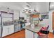 Charming kitchen featuring white cabinets, stainless appliances, wood-look flooring and granite countertops at 3530 Hamilton Rd, Lakeland, FL 33811