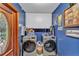 Well-lit laundry room featuring front-load machines and overhead storage, perfect for modern convenience at 3530 Hamilton Rd, Lakeland, FL 33811