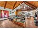Open-concept living area with vaulted wood ceilings, a loft, comfortable seating, and a view of the kitchen at 3530 Hamilton Rd, Lakeland, FL 33811
