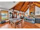 Open-concept living area features a stone fireplace, wood ceiling, and a rustic dining area with wood floors at 3530 Hamilton Rd, Lakeland, FL 33811