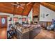 Open-concept living area with wood ceiling, stone fireplace, comfortable seating, and natural light at 3530 Hamilton Rd, Lakeland, FL 33811