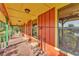 Long, covered porch with seating and view of surrounding landscape at 3530 Hamilton Rd, Lakeland, FL 33811