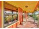 Long, covered porch featuring views of yard and open fields at 3530 Hamilton Rd, Lakeland, FL 33811