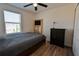 Bedroom with wood floors, ceiling fan, built in shelving, and natural light, creating a relaxing atmosphere at 3846 Exeter Ln, Lakeland, FL 33810