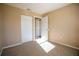 This bedroom features neutral paint and carpet with two closets at 404 Red Hawk Loop, Winter Haven, FL 33880