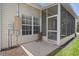 Exterior view of the screened-in lanai, showcasing the concrete patio and access to the yard at 4227 Hartridge Ln, Lakeland, FL 33813