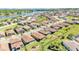 Expansive aerial view of a residential community featuring well-maintained homes and a scenic lake at 4232 Prima Lago Dr, Lakeland, FL 33810