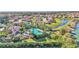 Overhead view of the community pool and clubhouse area, with lush landscaping near a winding stream and pond at 4232 Prima Lago Dr, Lakeland, FL 33810