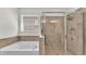 Bathroom featuring a soaking tub and tiled shower with glass enclosure at 4232 Prima Lago Dr, Lakeland, FL 33810