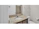 Bathroom with granite vanity and built-in cabinet at 4232 Prima Lago Dr, Lakeland, FL 33810
