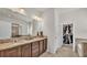 Bathroom with double vanity, granite countertop, and closet access at 4232 Prima Lago Dr, Lakeland, FL 33810