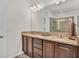 Bathroom featuring double sinks, granite counters, and walk-in shower at 4232 Prima Lago Dr, Lakeland, FL 33810