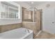 Bathroom featuring a soaking tub and walk-in shower with glass enclosure at 4232 Prima Lago Dr, Lakeland, FL 33810