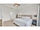 Bright primary bedroom with tray ceiling, neutral décor, and ensuite bathroom at 4232 Prima Lago Dr, Lakeland, FL 33810