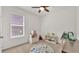 Neutral bedroom showcasing a patterned rug, shelving, and bright natural light at 4232 Prima Lago Dr, Lakeland, FL 33810