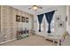 Charming bedroom features a rustic accent wall, playful decor, and ample natural light at 4232 Prima Lago Dr, Lakeland, FL 33810