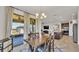 Dining room with chandelier, outdoor view, and connection to the kitchen and patio at 4232 Prima Lago Dr, Lakeland, FL 33810
