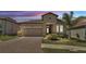 Charming single-Gathering home with a two-car garage, manicured lawn, and colorful landscaping at 4232 Prima Lago Dr, Lakeland, FL 33810