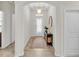 Bright foyer with neutral decor, a patterned rug, and an elegant console table at 4232 Prima Lago Dr, Lakeland, FL 33810