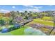 Scenic gazebo on a lake, with a wooden walkway and lush surroundings, providing a tranquil retreat at 4232 Prima Lago Dr, Lakeland, FL 33810