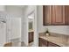 Hallway featuring granite counters, cabinetry, and entry to a bathroom at 4232 Prima Lago Dr, Lakeland, FL 33810