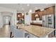 Spacious kitchen featuring granite countertops, stainless steel appliances, and a breakfast bar with seating at 4232 Prima Lago Dr, Lakeland, FL 33810