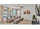 Cozy living room with large windows, neutral decor, and comfortable seating arrangement at 4232 Prima Lago Dr, Lakeland, FL 33810