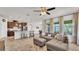 Comfortable open living space with large windows, ceiling fan, and direct access to kitchen at 4232 Prima Lago Dr, Lakeland, FL 33810