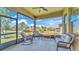 Enclosed patio features comfortable seating and views of the lush backyard at 4232 Prima Lago Dr, Lakeland, FL 33810