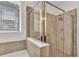 Tiled shower with glass enclosure and window at 4232 Prima Lago Dr, Lakeland, FL 33810