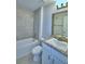 Bathroom features a bathtub, shower, vanity and tiled wall at 4322 Juliana Lake Dr, Auburndale, FL 33823