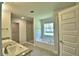 Bathroom featuring double vanity, soaking tub, glass shower and natural lighting at 4322 Juliana Lake Dr, Auburndale, FL 33823