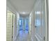 Hallway with tiled floors and multiple doors leading to bedrooms and living areas at 4322 Juliana Lake Dr, Auburndale, FL 33823