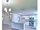 Kitchen boasts modern appliances, blue oven, white cabinets, and bar with granite countertops at 4322 Juliana Lake Dr, Auburndale, FL 33823