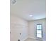 Laundry room features tiled floor, overhead shelving, and exterior door access at 4322 Juliana Lake Dr, Auburndale, FL 33823