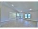 Spacious living area with tiled flooring, recessed lighting, and a seamless flow to other rooms at 4322 Juliana Lake Dr, Auburndale, FL 33823