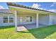 Covered patio overlooks the grassy yard and brick pavers at 4322 Juliana Lake Dr, Auburndale, FL 33823
