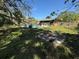 Exterior view of the home's yard and pool, shaded by trees at 460 W Pierce St, Lake Alfred, FL 33850