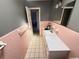 Bathroom with a tiled wall, and vanity with integrated sink at 460 W Pierce St, Lake Alfred, FL 33850