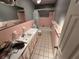 Bathroom featuring a tiled tub, toilet, vanity with integrated sink at 460 W Pierce St, Lake Alfred, FL 33850