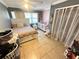A well-lit primary bedroom with a tile floor and a ceiling fan at 460 W Pierce St, Lake Alfred, FL 33850