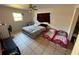 Bright bedroom with a ceiling fan and multiple beds near a window at 460 W Pierce St, Lake Alfred, FL 33850